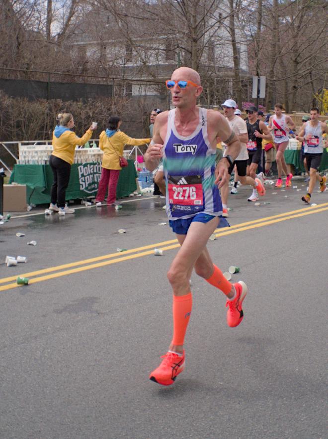 A bald runner with sunglasses and a shirt that reads &ldquo;Tony&rdquo; in a handwritten font.